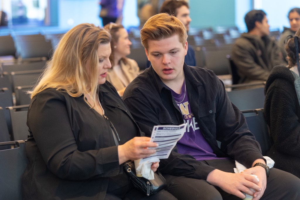 Two individuals reviewing a flyer together.