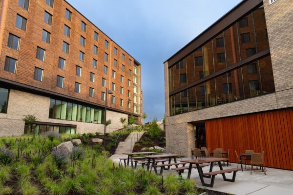 A group of buildings with tables and chairs