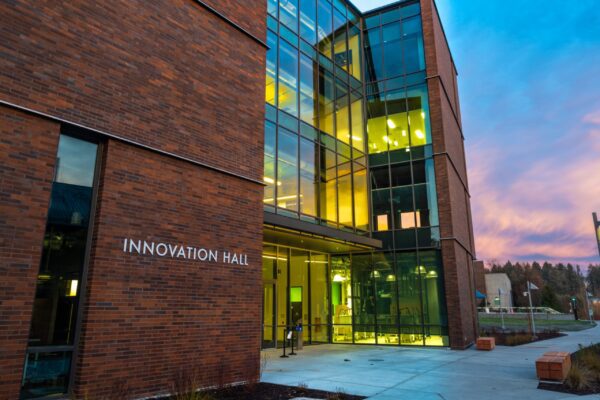 A building with glass walls and a sign