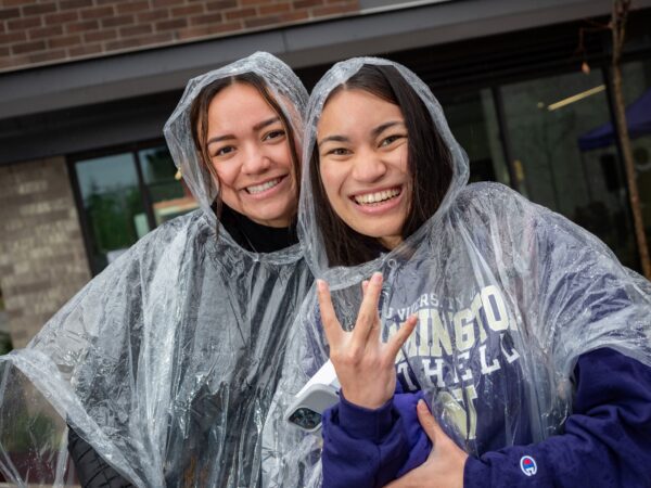 Two women wearing rain ponchos.