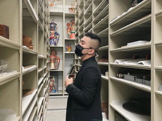 Nguyen, a senior in the School of IAS looking through museum shelves