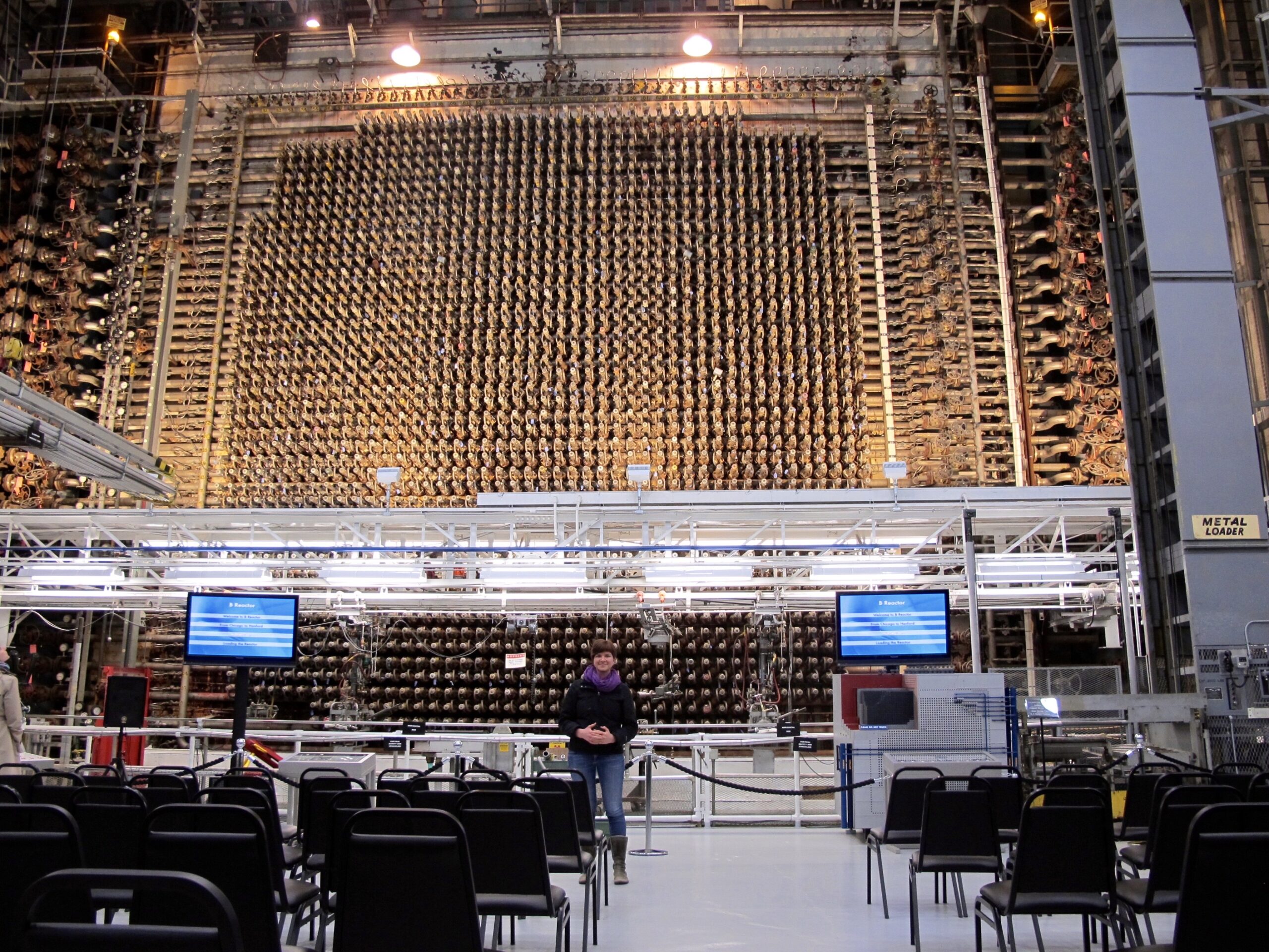 A person standing in a nuclear reactor building.