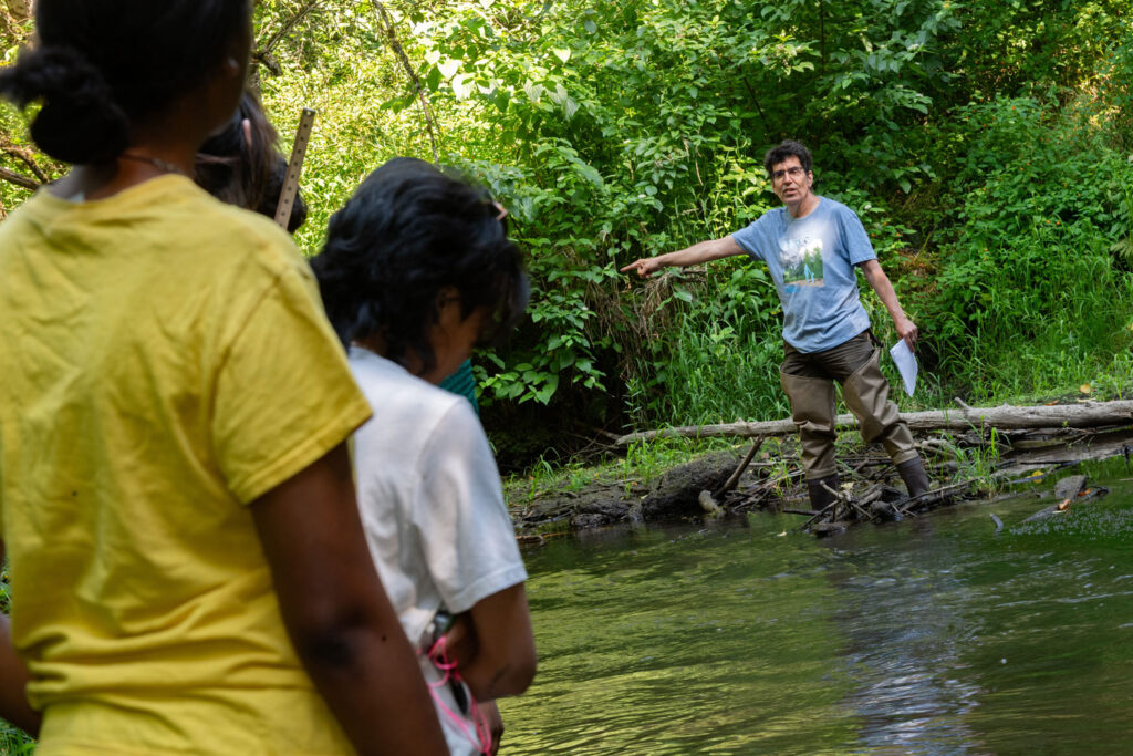 A group of people in a wetland area.