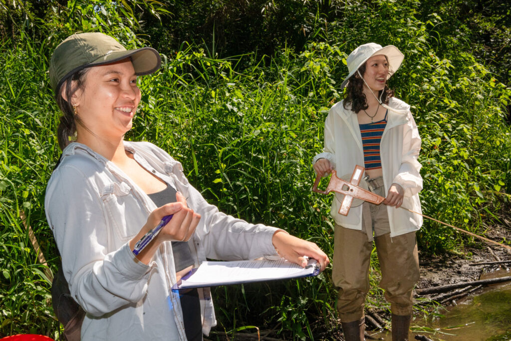 A group of people in a wetland area.