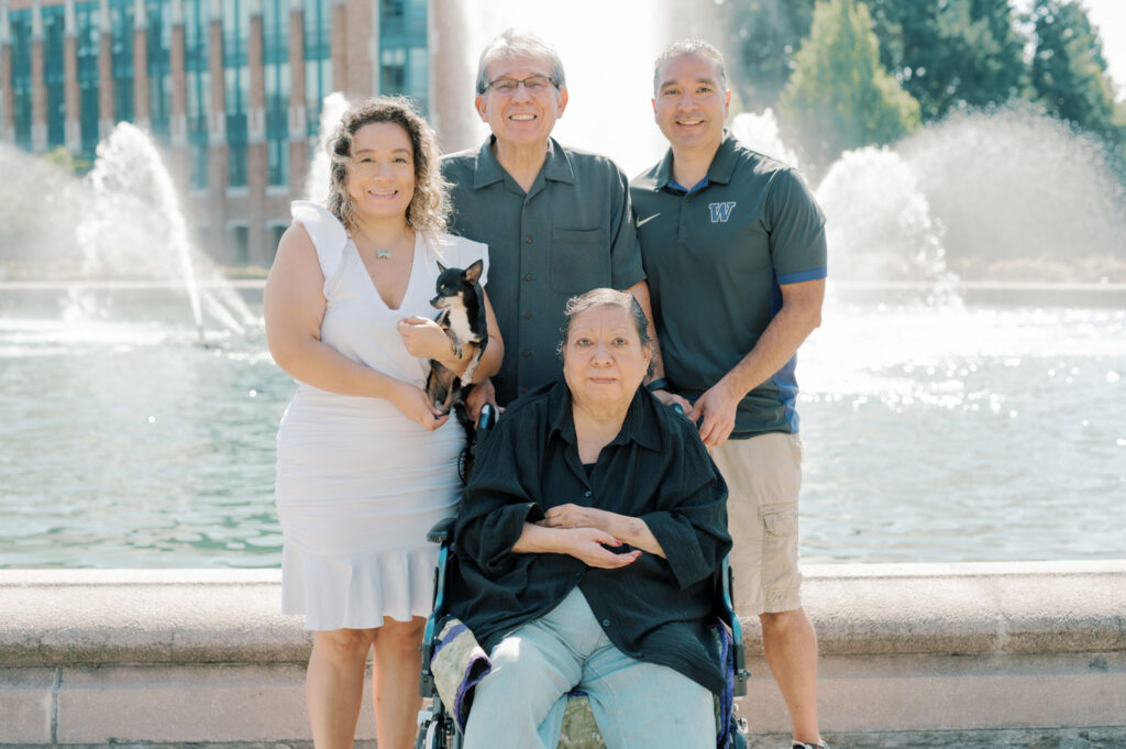 A group of people in front of a fountain.