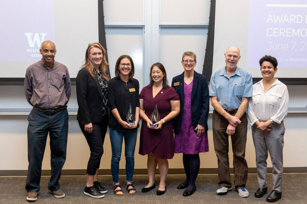 A group of seven people pose for a photo.