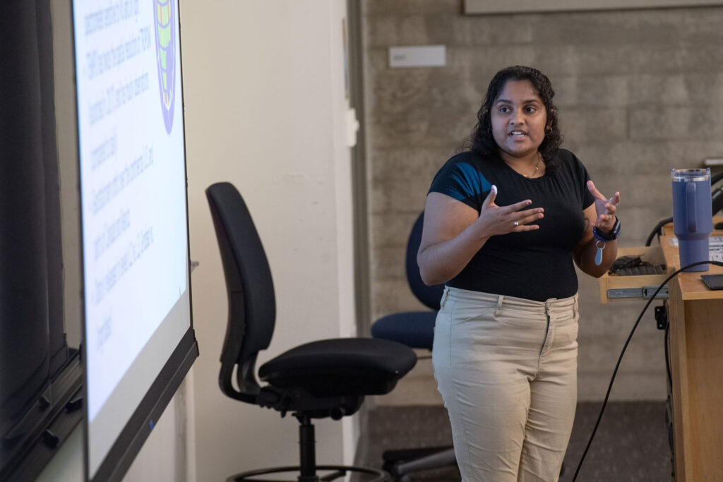 A person presenting at a podium.