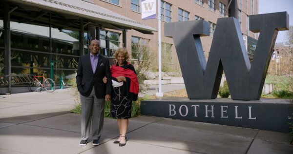 Two people near a "W" sign.