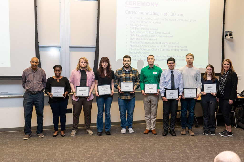 Engineering and mathematics division chair Tadesse Ghirmai posing with students who received their awards.