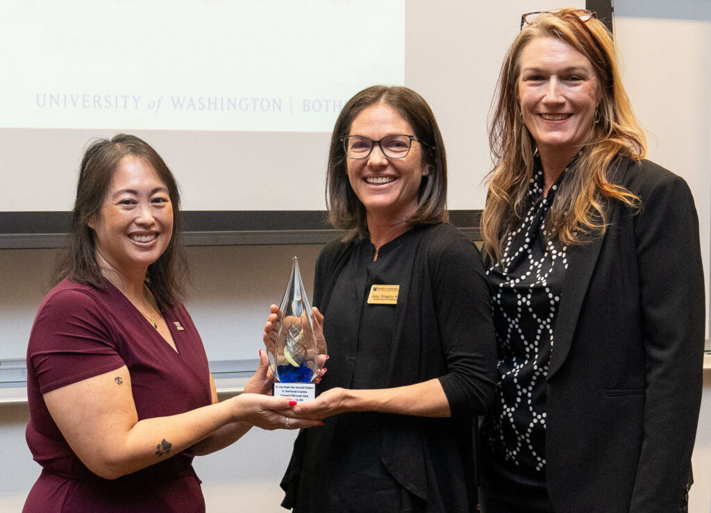 Michelle Gamboa awarding the inaugural Sr. Chief Ronald G. Gamboa Endowed UW Bothell STEM Faculty Fellowship to Dr. Joey Shapiro Key with interim Dean Jennifer McLoud-Mann.