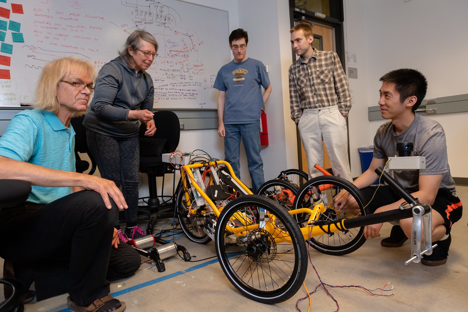 Tyler Folsom and team with two trikes