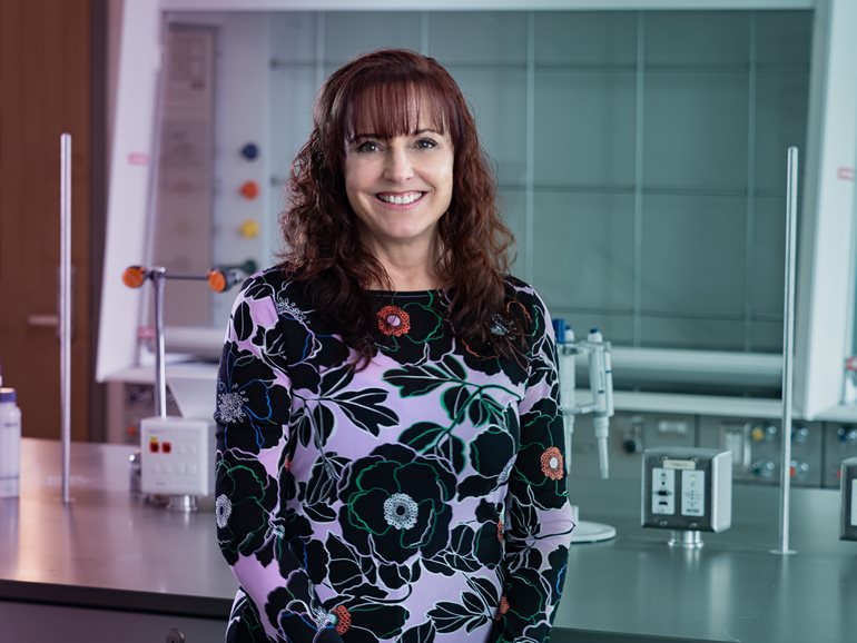 Dean Leslie Cornick smiling in a laboratory on campus