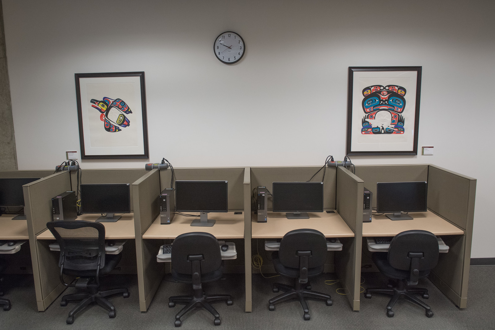 Computer bays that include a monitor, desktop computer, keyboard and mouse in the library