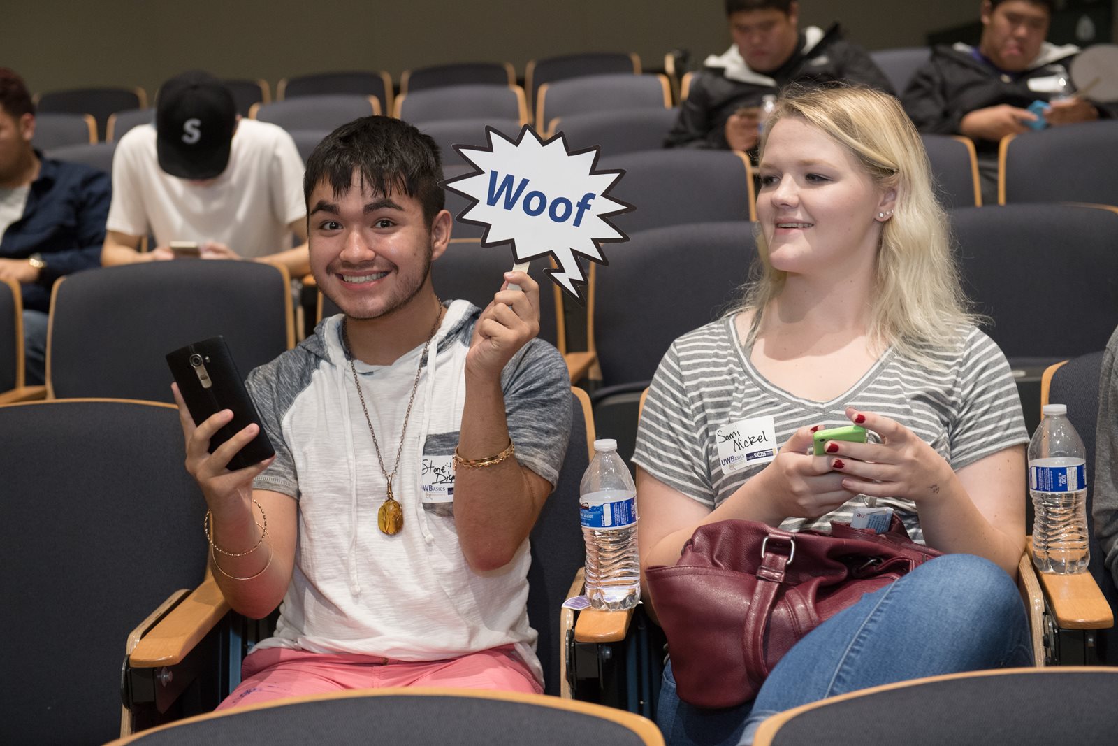 student holding "woof" sign