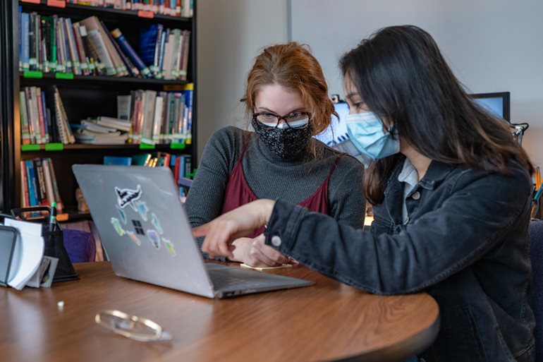 WaCC tutor helping a student at the Pathways event 